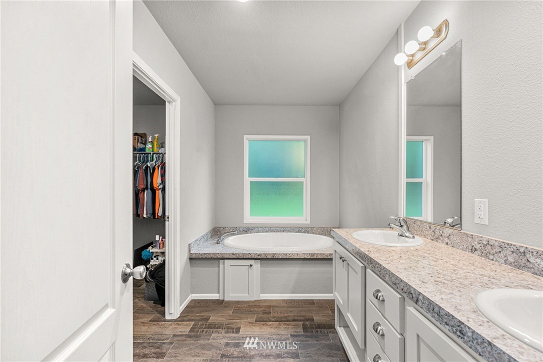 40822 Dorman Road Gold Bar, WA 98251 - Photo 22 of 34 a bathroom with a granite countertop sink a toilet and a window