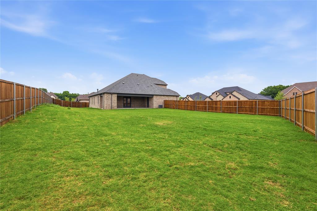 702 Anne Road Van Alstyne, TX 75495 - Photo 27 of 27 Expansive green lawn with a full wood privacy fence