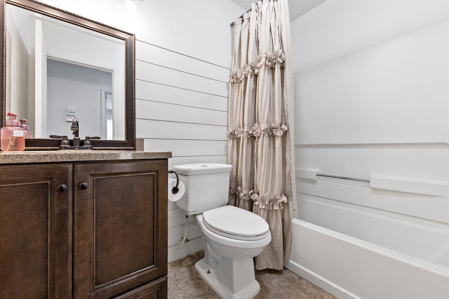 398 Helena Way Madera, CA 93637 - Photo 13 of 23 a bathroom with a sink a toilet and shower