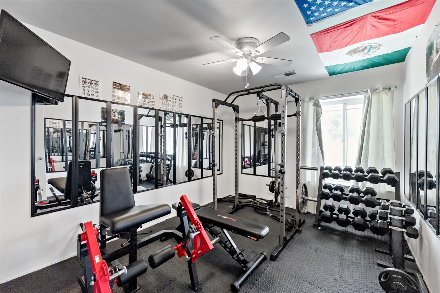 398 Helena Way Madera, CA 93637 - Photo 14 of 23 a room with gym equipment and a flat screen tv
