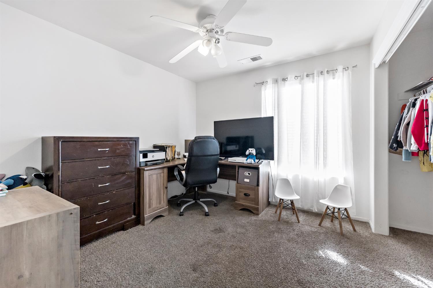 398 Helena Way Madera, CA 93637 - Photo 15 of 23 a view of a workspace with furniture and a window