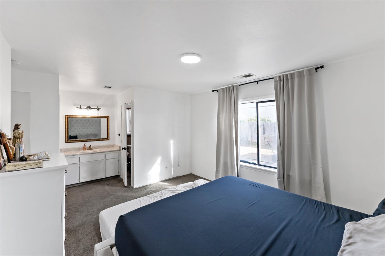 398 Helena Way Madera, CA 93637 - Photo 16 of 23 a bedroom with a bed and a flat screen tv