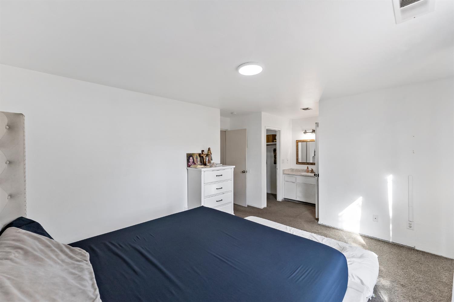 398 Helena Way Madera, CA 93637 - Photo 17 of 23 a view of a bedroom with furniture and refrigerator