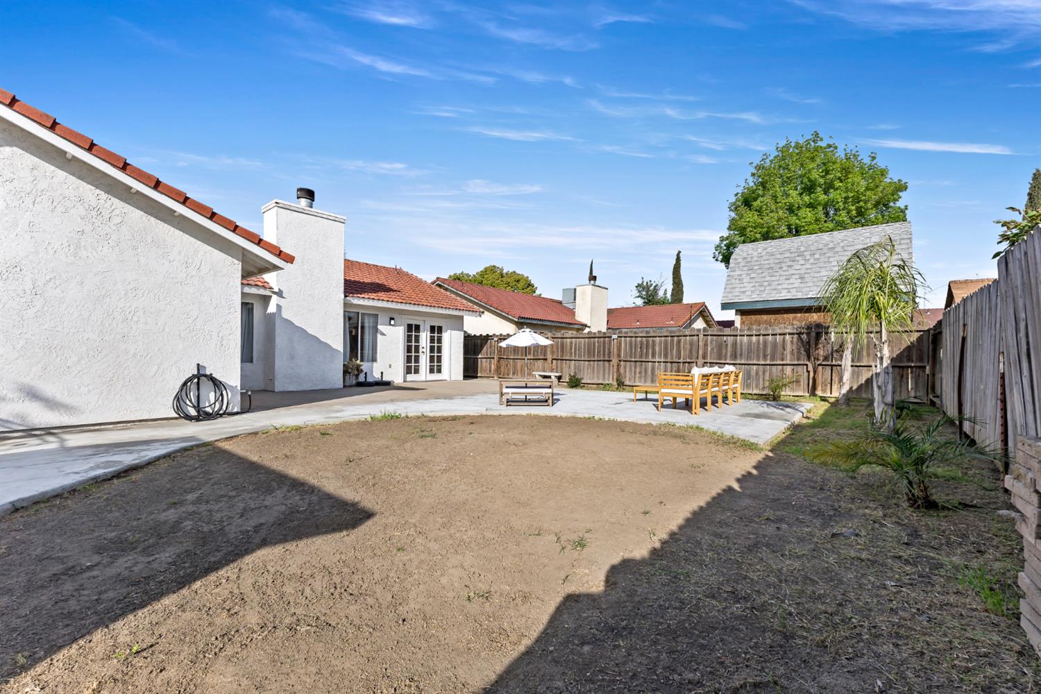 398 Helena Way Madera, CA 93637 - Photo 21 of 23 a city street lined with buildings and trees