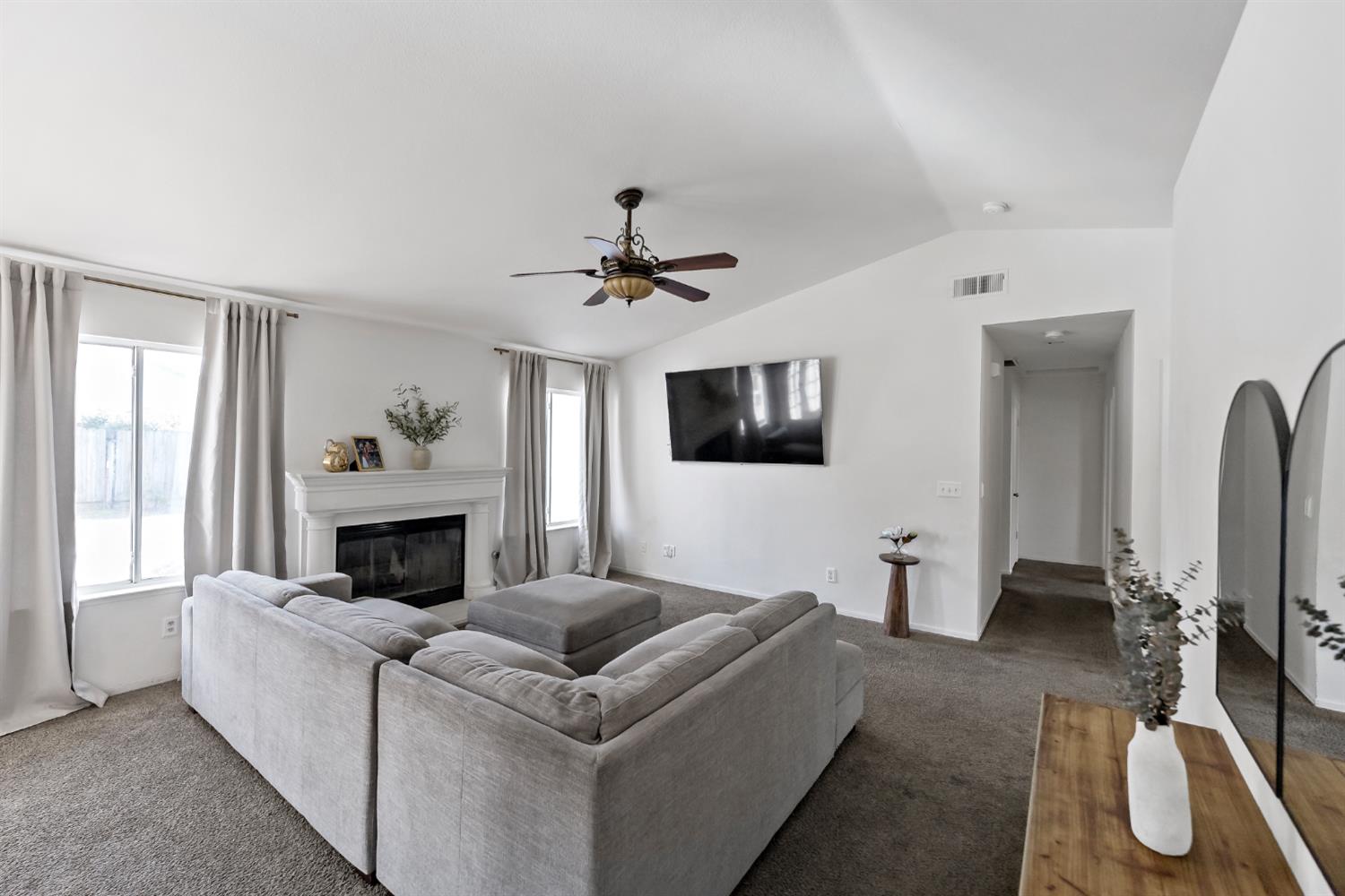 398 Helena Way Madera, CA 93637 - Photo 6 of 23 a living room with furniture and a fireplace