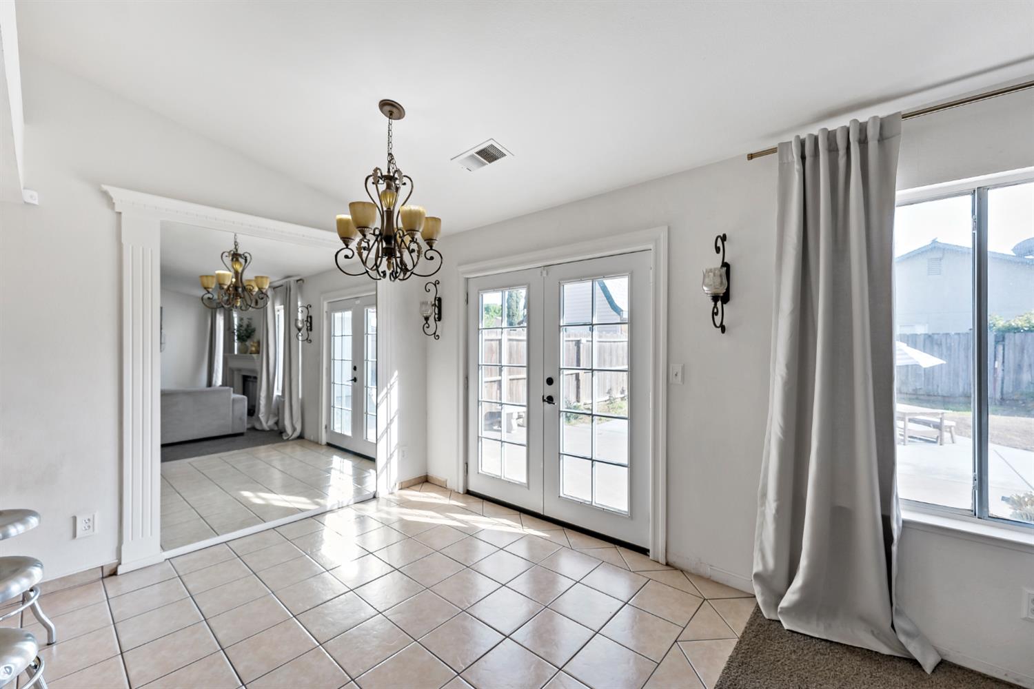 398 Helena Way Madera, CA 93637 - Photo 10 of 23 a view of a chandelier in big room with windows and chandelier