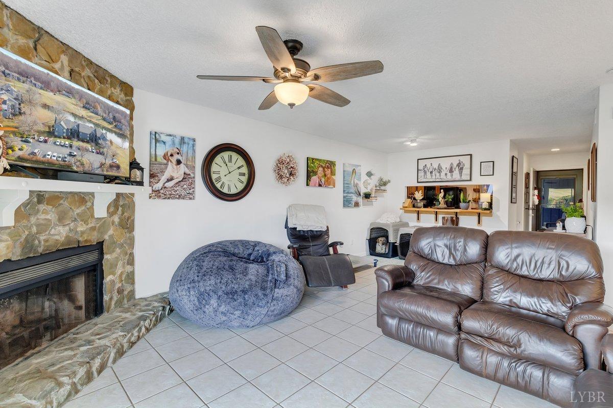 2404 Deer Run Forest, VA 24551 - Photo 14 of 32 a living room with furniture a clock and a fireplace