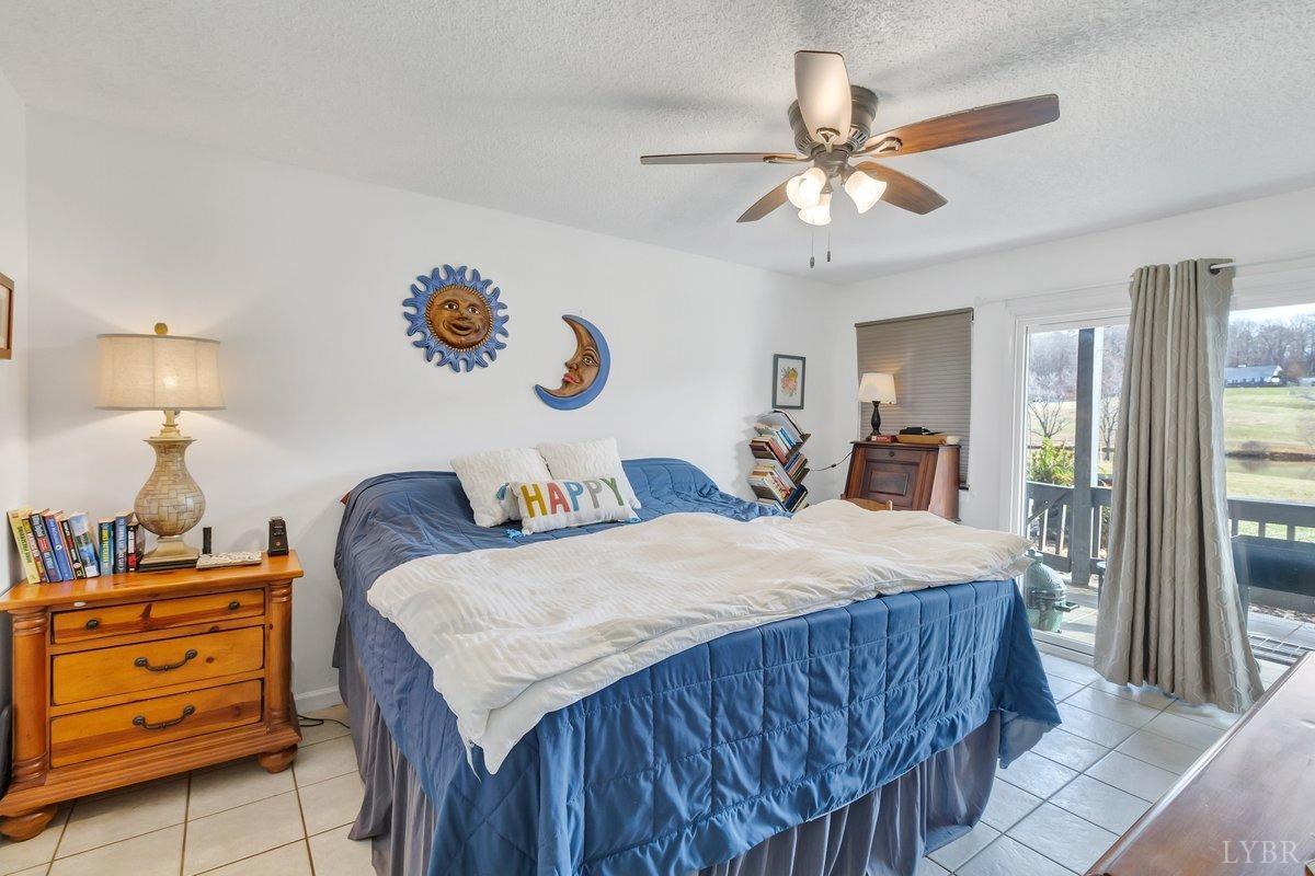 2404 Deer Run Forest, VA 24551 - Photo 15 of 32 a bed room with a bed and a chandelier