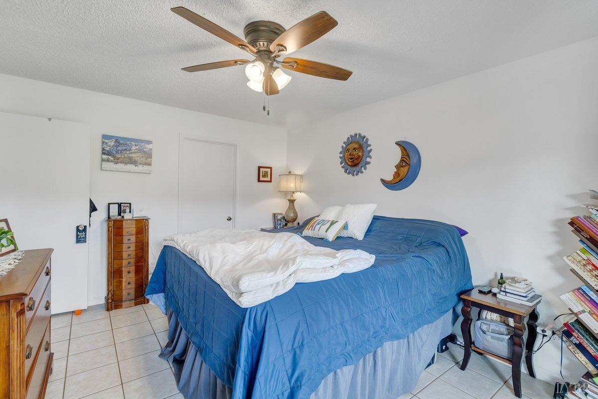 2404 Deer Run Forest, VA 24551 - Photo 16 of 32 a bedroom with a bed and a chandelier