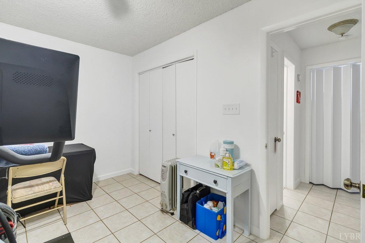 2404 Deer Run Forest, VA 24551 - Photo 25 of 32 a hallway with a chair and a fireplace