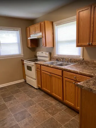 a kitchen with stainless steel appliances granite countertop a sink stove and microwave