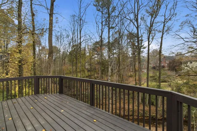 a view of a balcony with wooden floor and fence