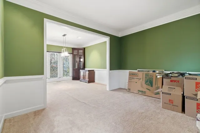 a view of an empty room with a kitchen