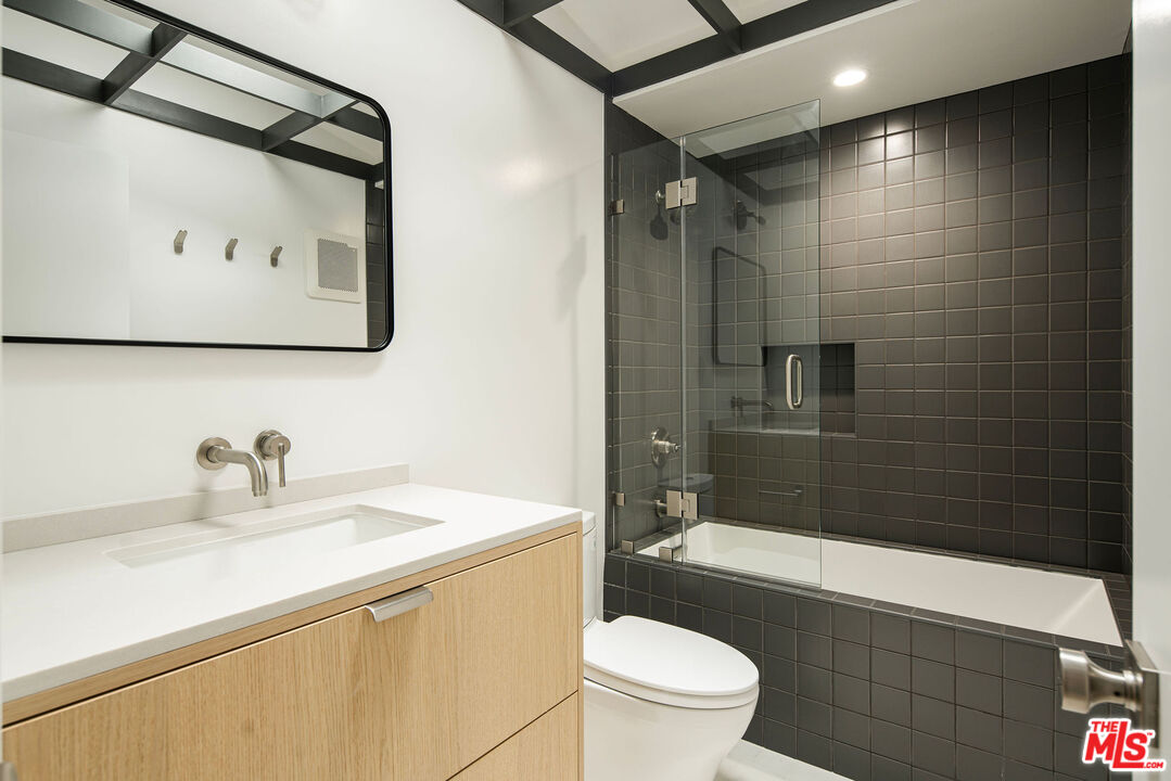 11368 Berwick Street Los Angeles, CA 90049 - Photo 13 of 27 a bathroom with a sink a toilet and shower
