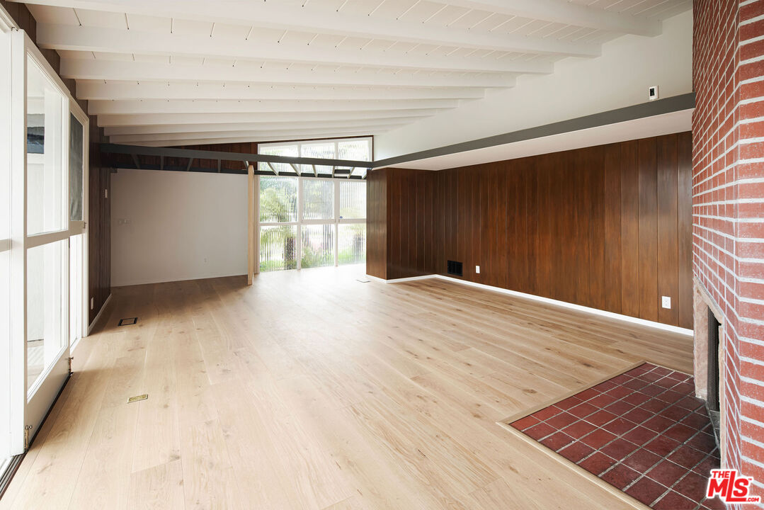 11368 Berwick Street Los Angeles, CA 90049 - Photo 8 of 27 a view of an empty room with wooden floor and a window