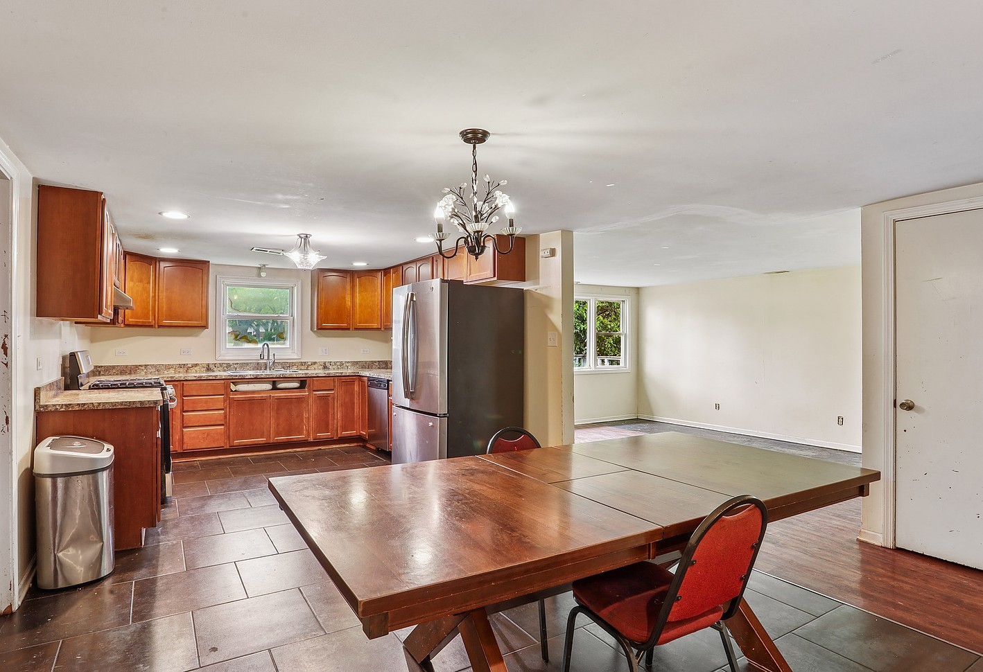 26835 South Linden Lane Crete, IL 60417 - Photo 2 of 13 a kitchen with stainless steel appliances granite countertop a stove top oven a sink dishwasher a dining table and chairs with wooden floor