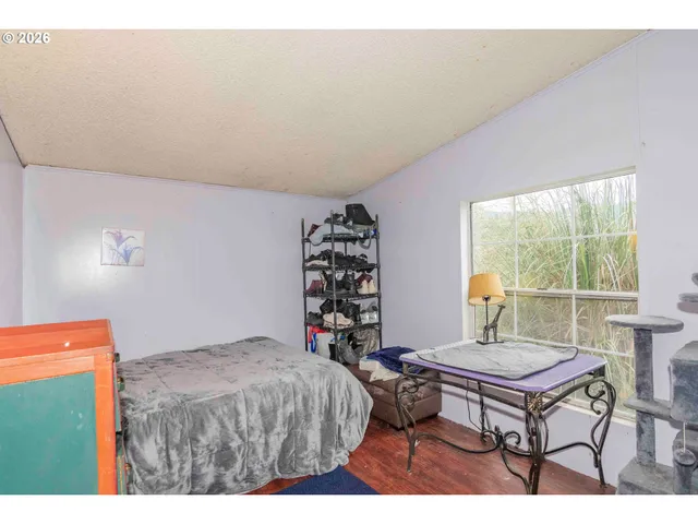 a bed room with a bed and a window