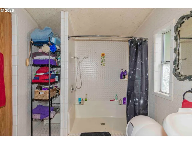 a view of walk in closet with clothes