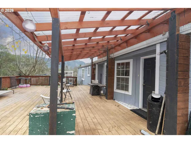 a view of a patio with table and chairs and wooden floor