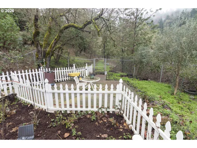 a view of a house with backyard and sitting area