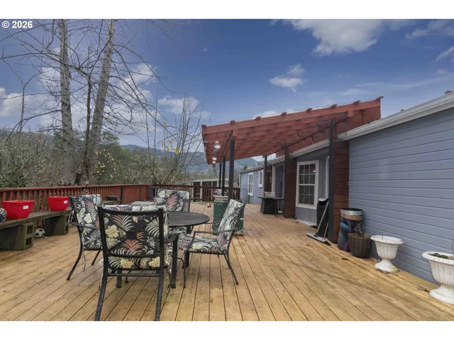 a view of a wooden deck with a yard