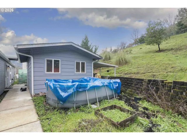 a house view with a sitting space and garden