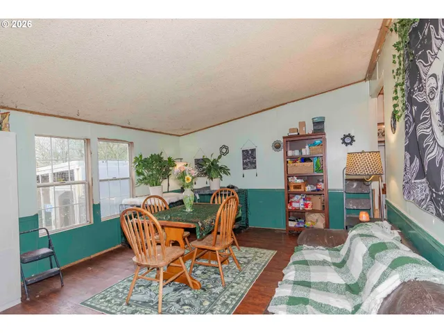 a view of a dining room with furniture and a rug