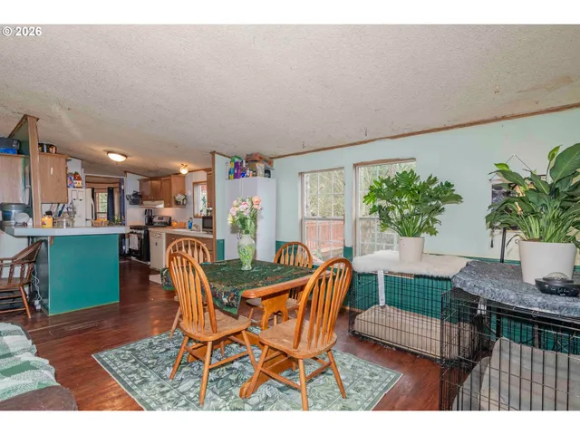 a dining room with furniture and a potted plant