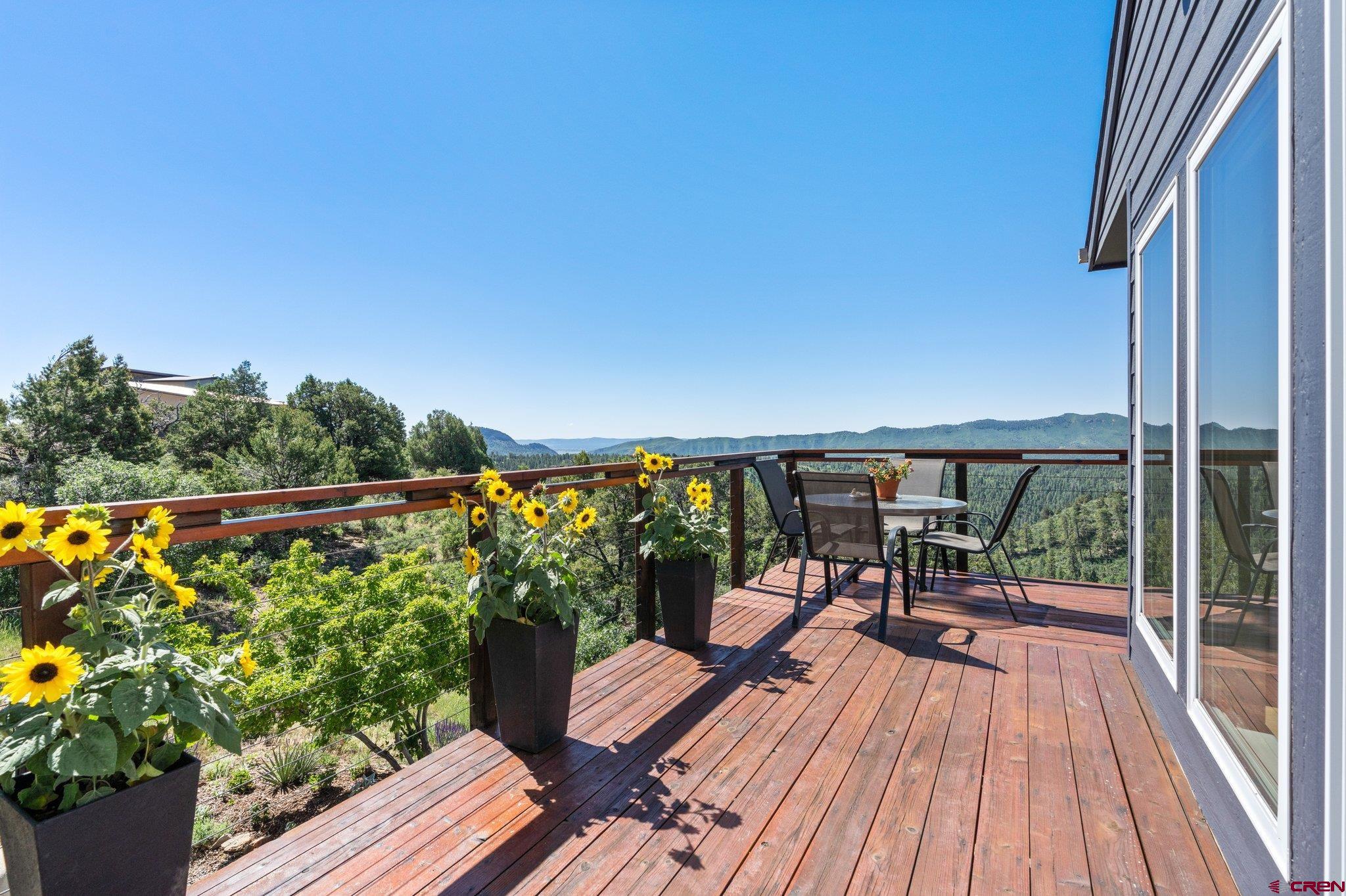 1584 Ridge Road Durango, CO 81303 - Photo 26 of 35 a view of a balcony with chairs and wooden floor