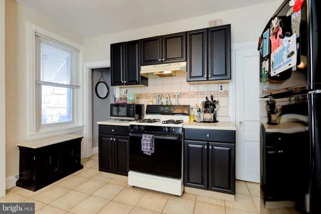 a kitchen with stainless steel appliances granite countertop a stove a refrigerator and a sink