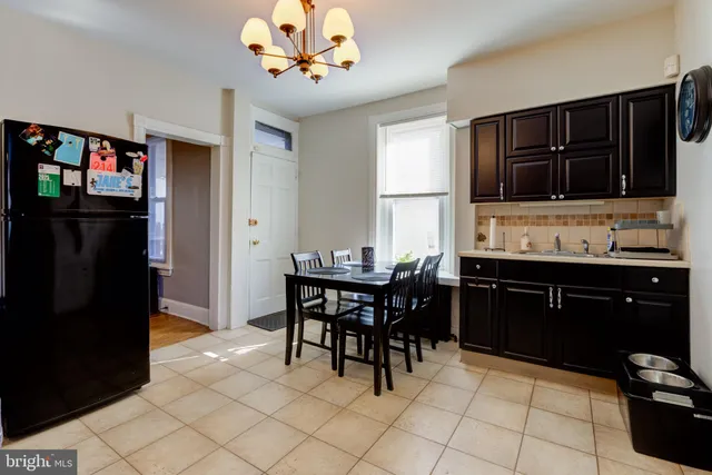 a kitchen with a refrigerator and a sink