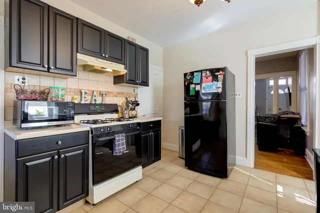 a kitchen with a refrigerator and cabinets