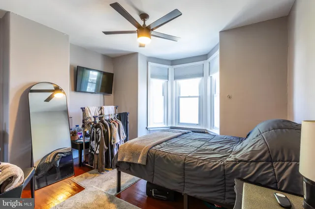 a bed sitting in a bedroom next to a window
