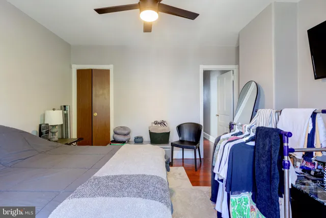a bedroom with bed and a chandelier