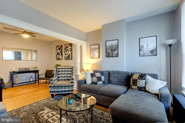 a living room with furniture and wooden floor
