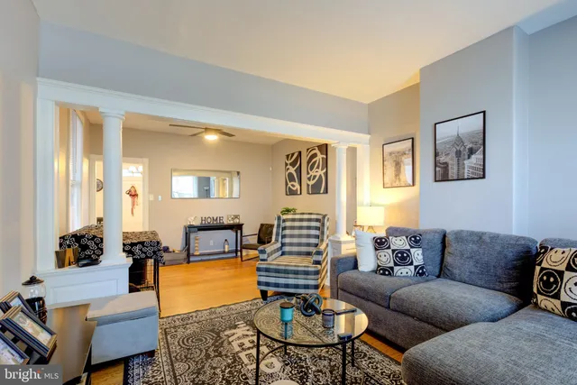 a living room with furniture and a fireplace