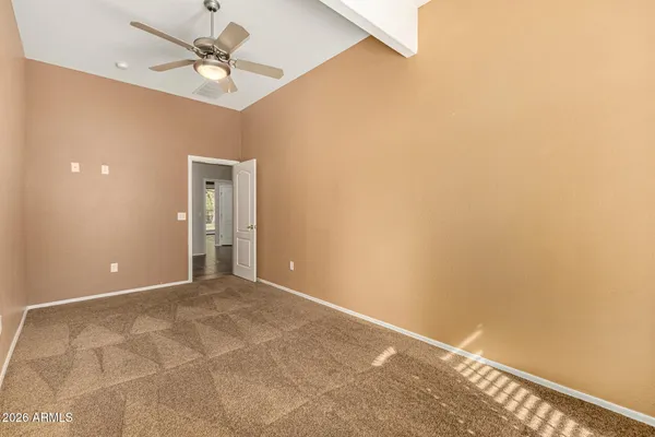 a view of empty room with wooden floor and fireplace