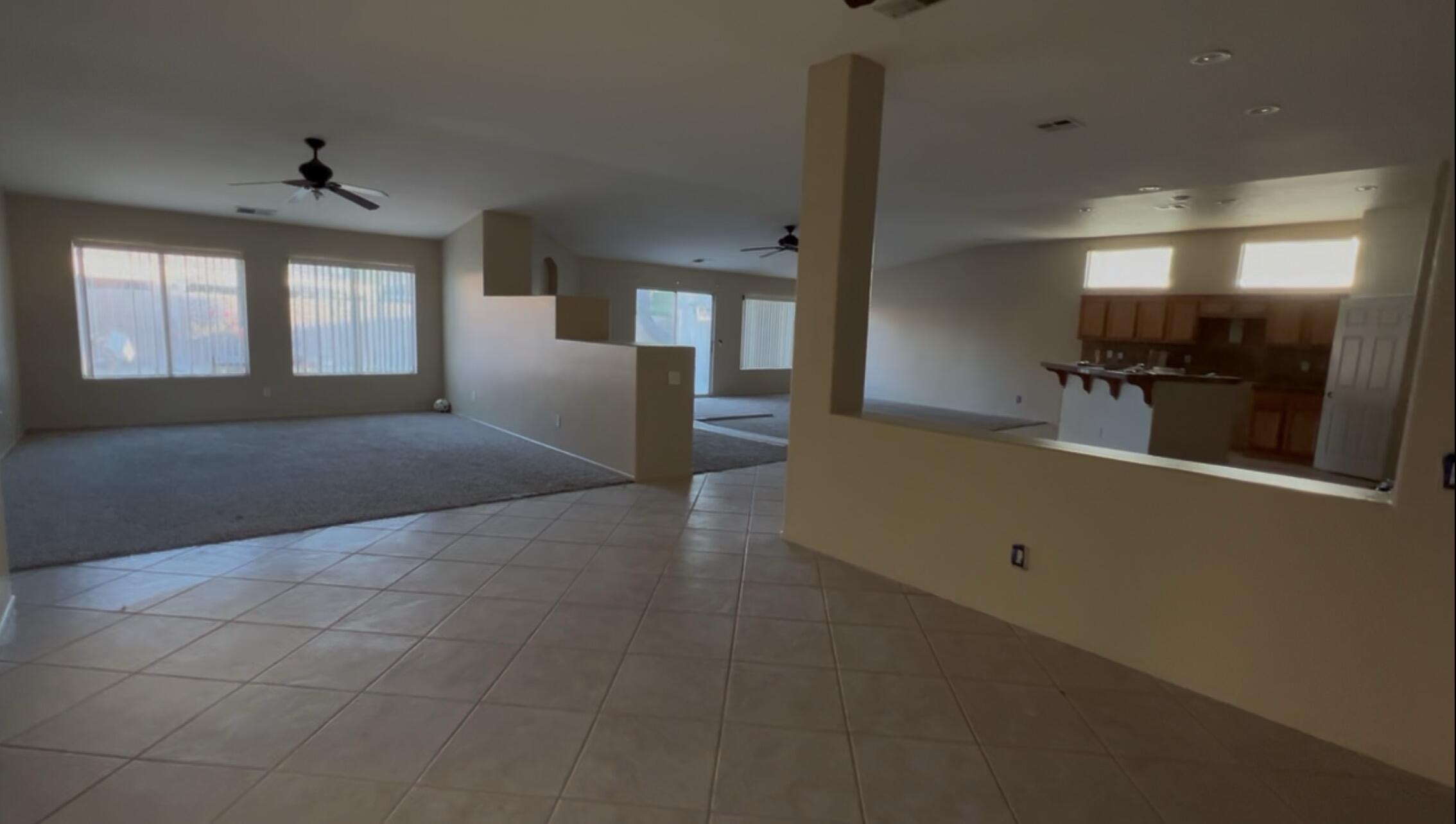 47750 Mirage Way Indio, CA 92201 - Photo 4 of 26 a view of a hallway with wooden floor and a living room