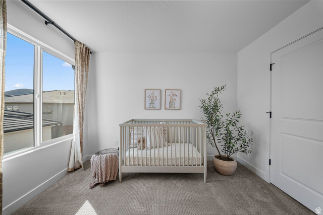 382 North Rhyolite Drive, Unit 111 Hurricane, UT 84737 - Photo 28 of 37 Bright room with a large window, neutral wall paint, and gray carpet flooring