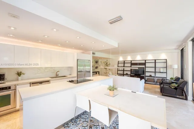 a kitchen with stainless steel appliances kitchen island granite countertop a sink and cabinets