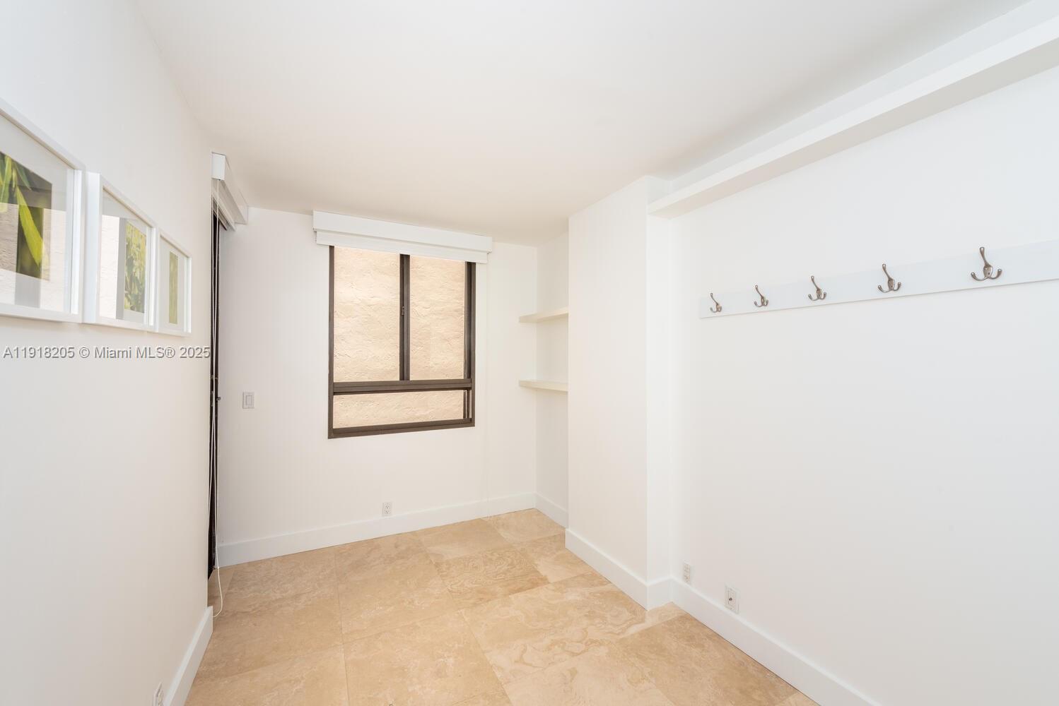 141 Crandon Boulevard, Unit 235 Key Biscayne, FL 33149 - Photo 14 of 25 a view of an empty room with a window