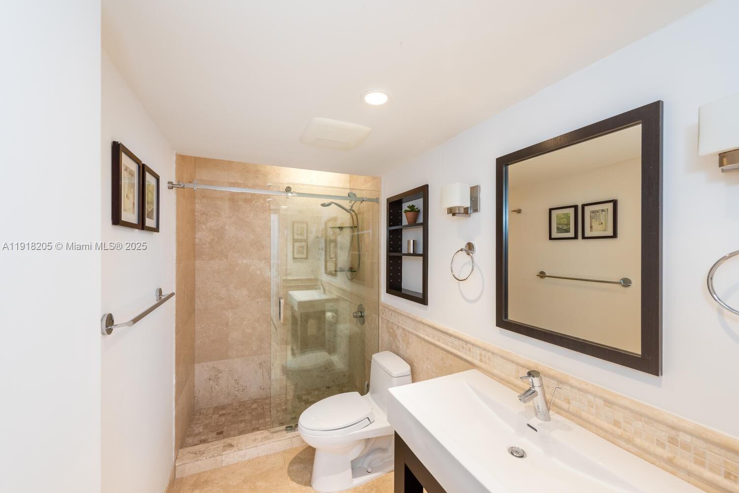 141 Crandon Boulevard, Unit 235 Key Biscayne, FL 33149 - Photo 16 of 25 a bathroom with a sink toilet and shower