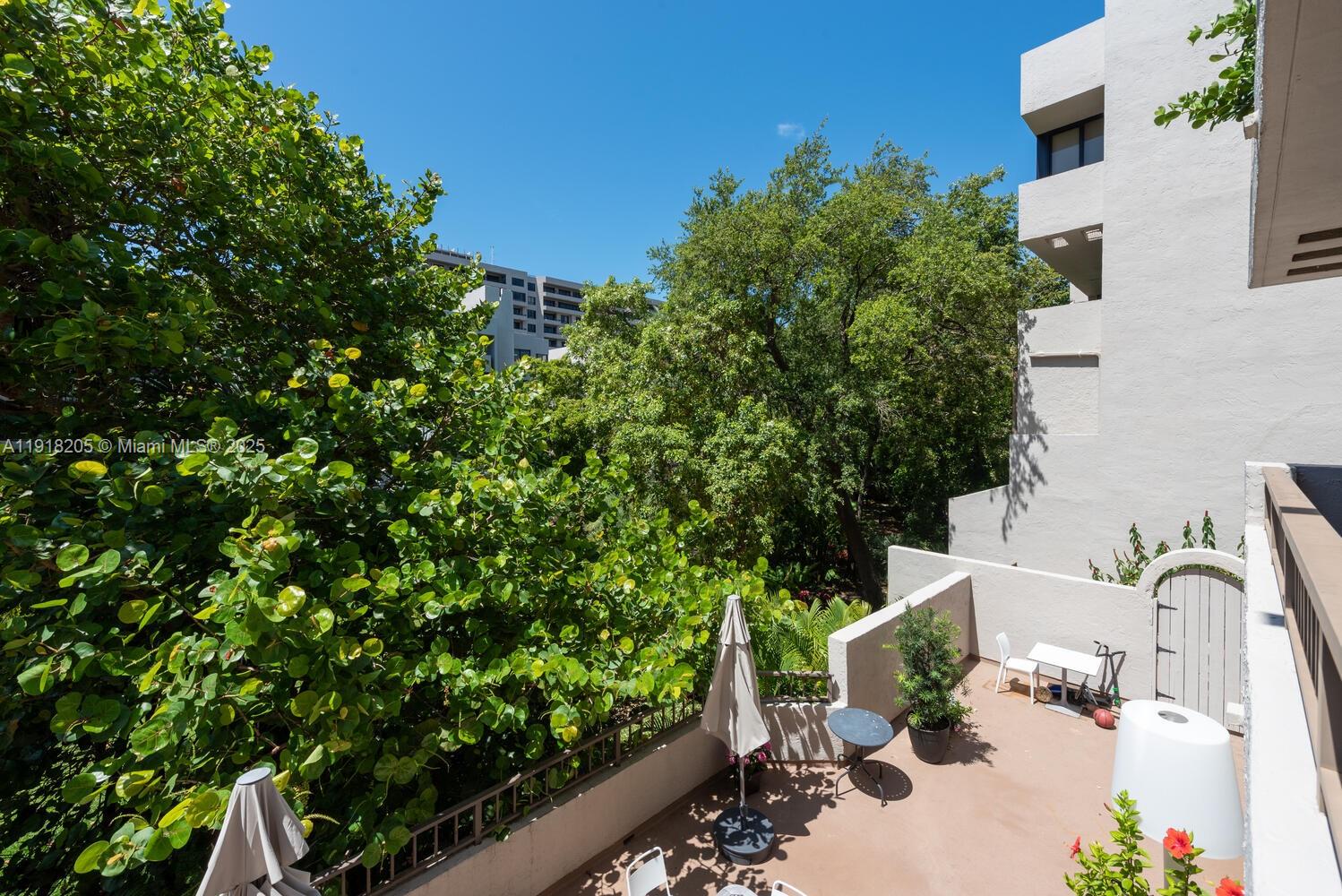 141 Crandon Boulevard, Unit 235 Key Biscayne, FL 33149 - Photo 4 of 25 a backyard of a house with lots of green space