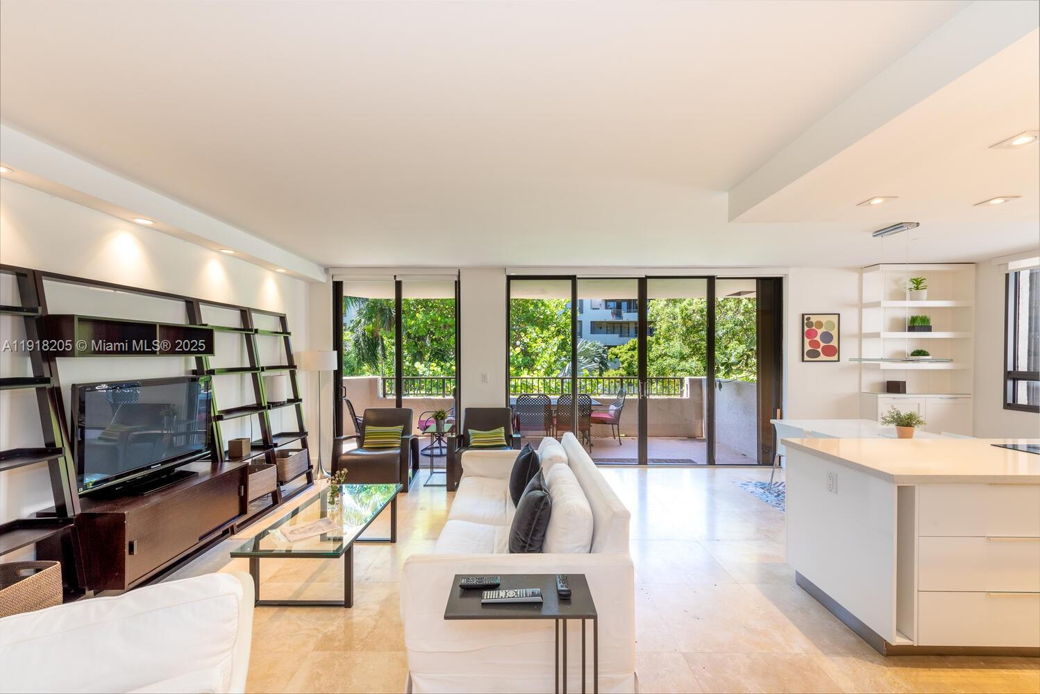 141 Crandon Boulevard, Unit 235 Key Biscayne, FL 33149 - Photo 5 of 25 a living room with furniture tv and a large window