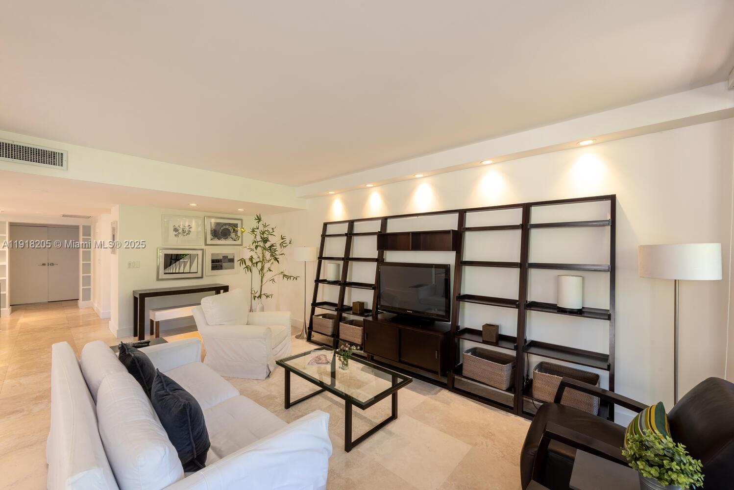 141 Crandon Boulevard, Unit 235 Key Biscayne, FL 33149 - Photo 7 of 25 a bedroom with furniture and a wooden floor