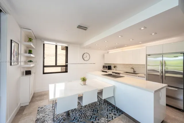 a kitchen with a sink appliances and cabinets
