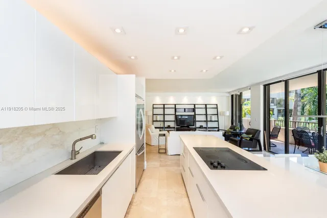 a kitchen with a sink and a stove top oven