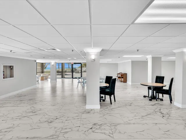 a lobby with furniture and floor to ceiling window