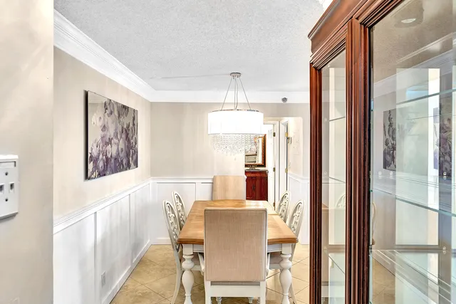 a kitchen with granite countertop white cabinets and stainless steel appliances