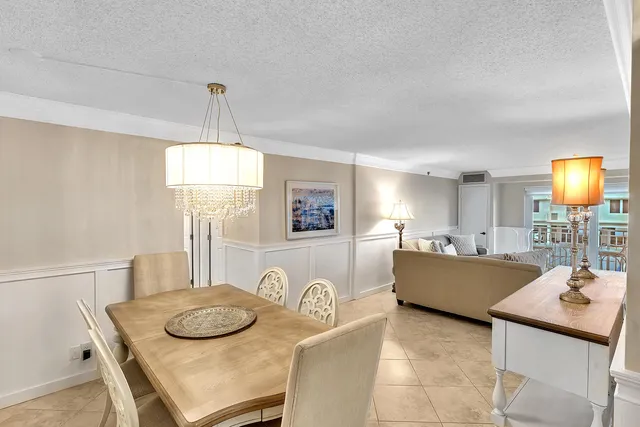 a living room with furniture a flat screen tv and a large window
